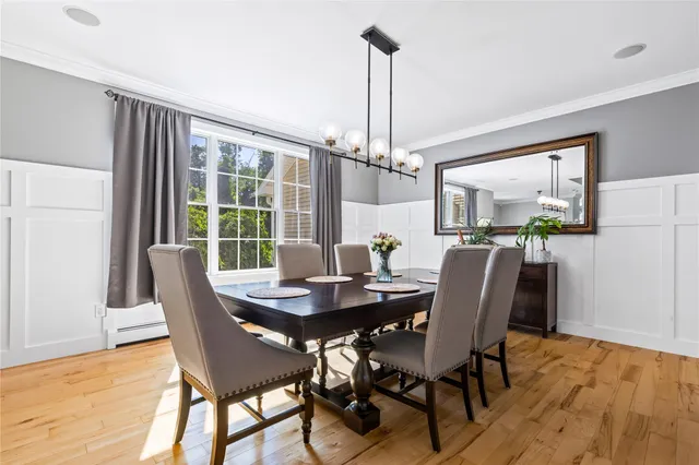 a view of a dining room with furniture wooden floor and a chandelier