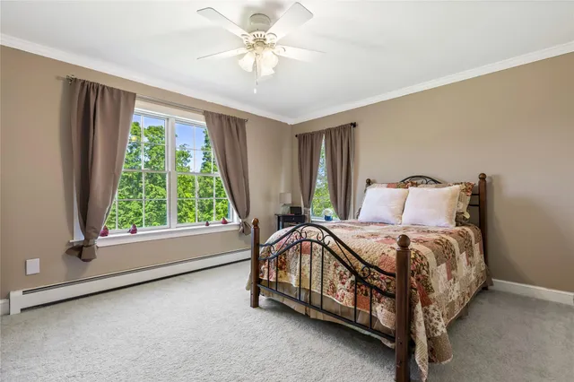 a dining room with furniture a chandelier and wooden floor
