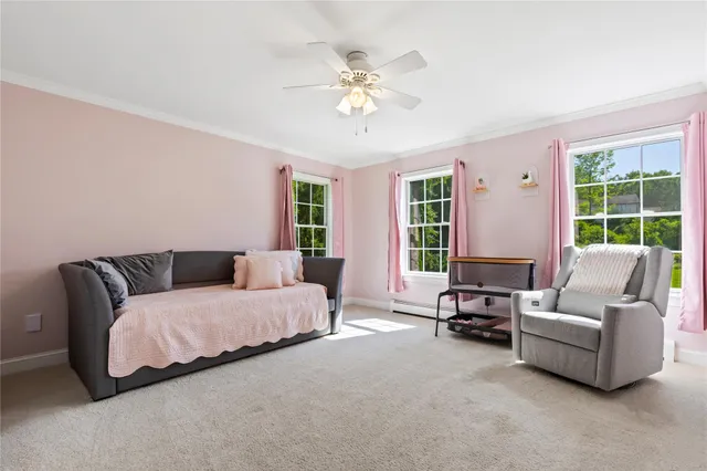 a bed sitting in a spacious bedroom next to a window