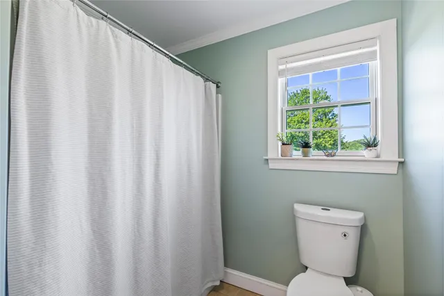 a bathroom with a toilet a sink and a mirror