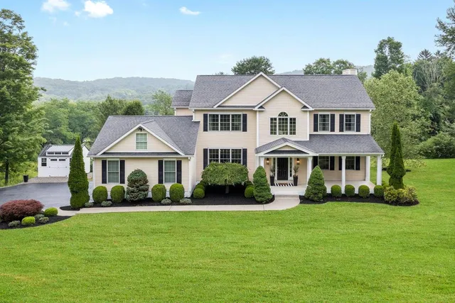 a front view of a house with a garden