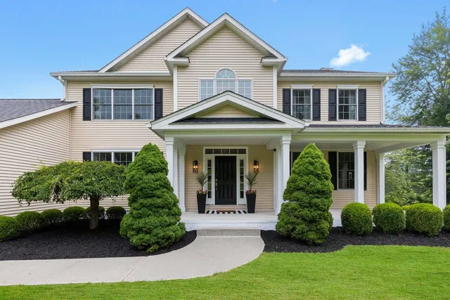 a front view of a house with a yard