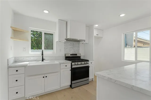 a kitchen with cabinets appliances and a window