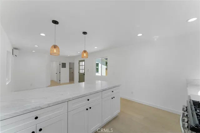 a large kitchen with a lot of cabinet and a large mirror