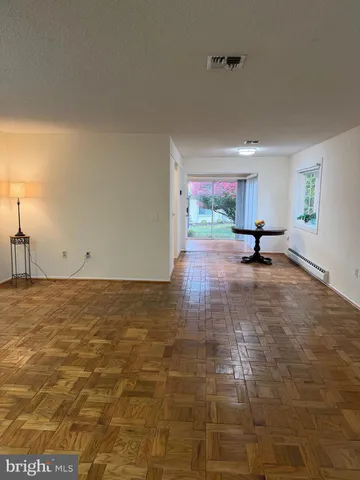 a view of a livingroom with wooden floor and a window