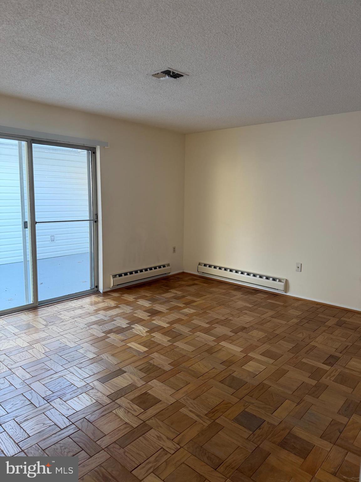15418 Bramblewood Drive, Unit 20C Silver Spring, MD 20906 - Photo 9 of 18 an empty room with natural light