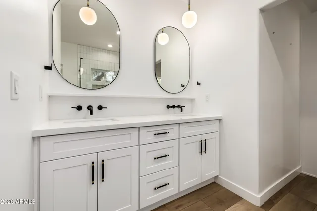 a bathroom with 2 sink and a mirror