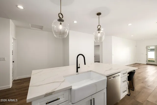 a kitchen with a sink a counter space and a dining table