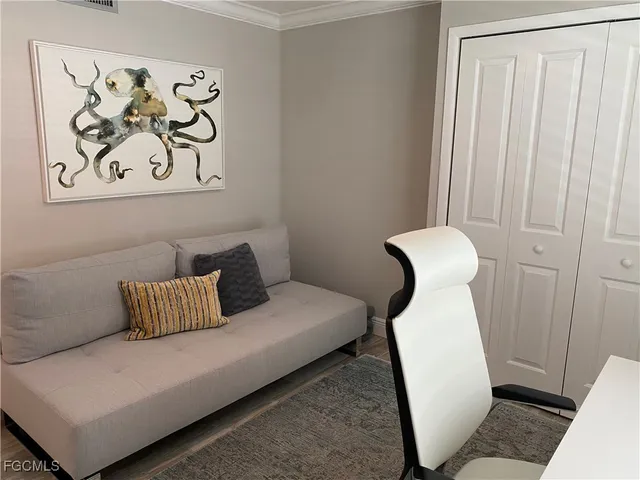 a white couch sitting next to a white cabinet