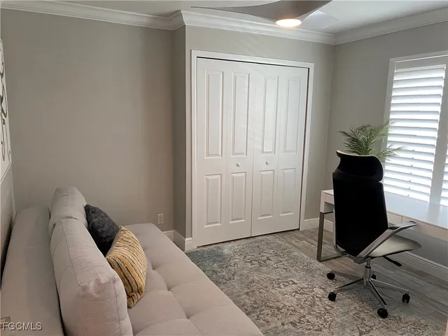 a view of a livingroom with workspace and a window