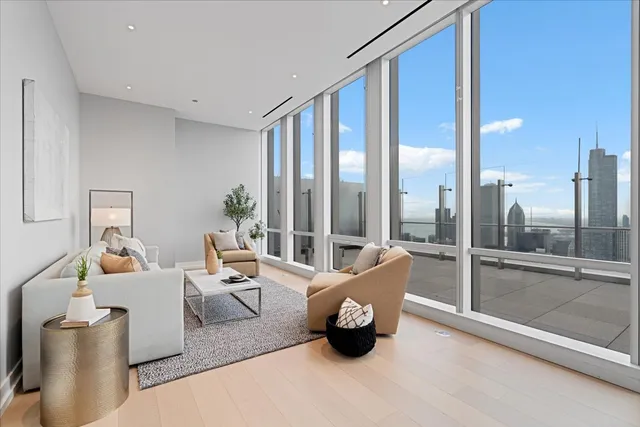 a living room with furniture and a floor to ceiling window