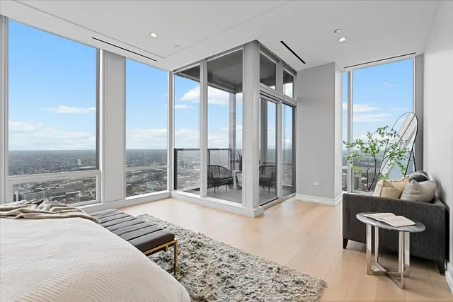 a bedroom with furniture and a large window