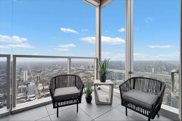 a balcony with furniture and a potted plant
