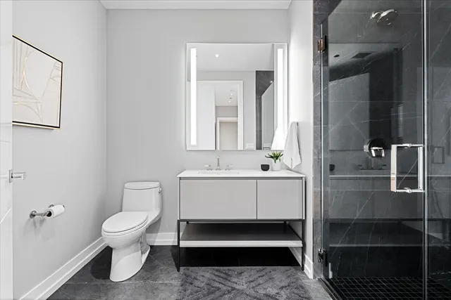 a bathroom with a white toilet and a shower