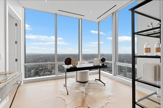 a living room with a large window and furniture