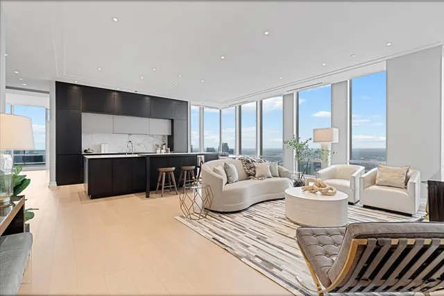 a living room with furniture and large windows