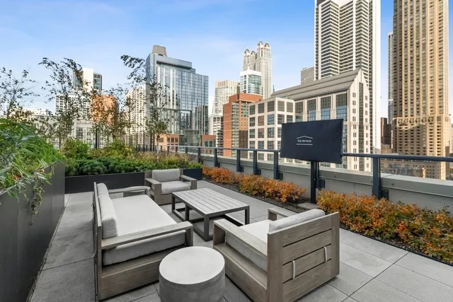 a roof deck with couch and outdoor seating