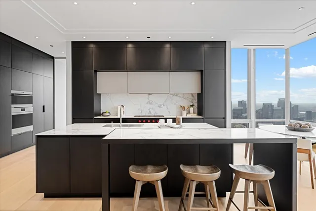 a kitchen with a table chairs sink and cabinets