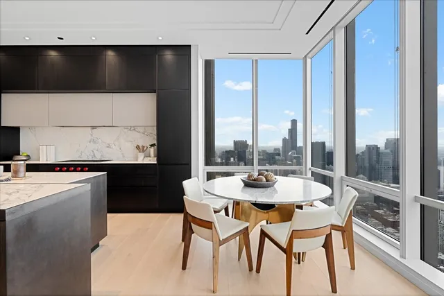 a dining room with a large window and table