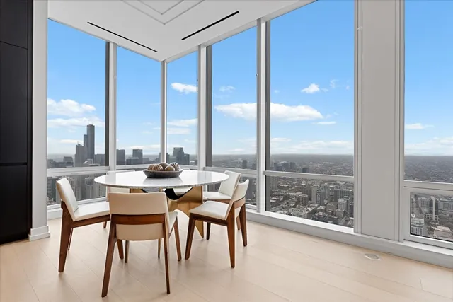 a dining room with furniture and a floor to ceiling window