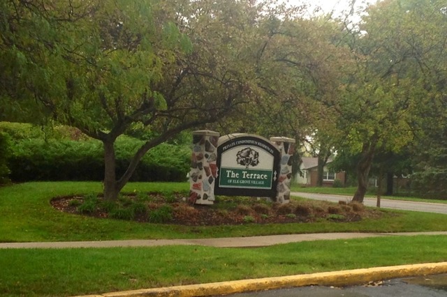 924 Ridge Square, Unit 118 Elk Grove Village, IL 60007 - Photo 2 of 10 a view of a park that has a sign board