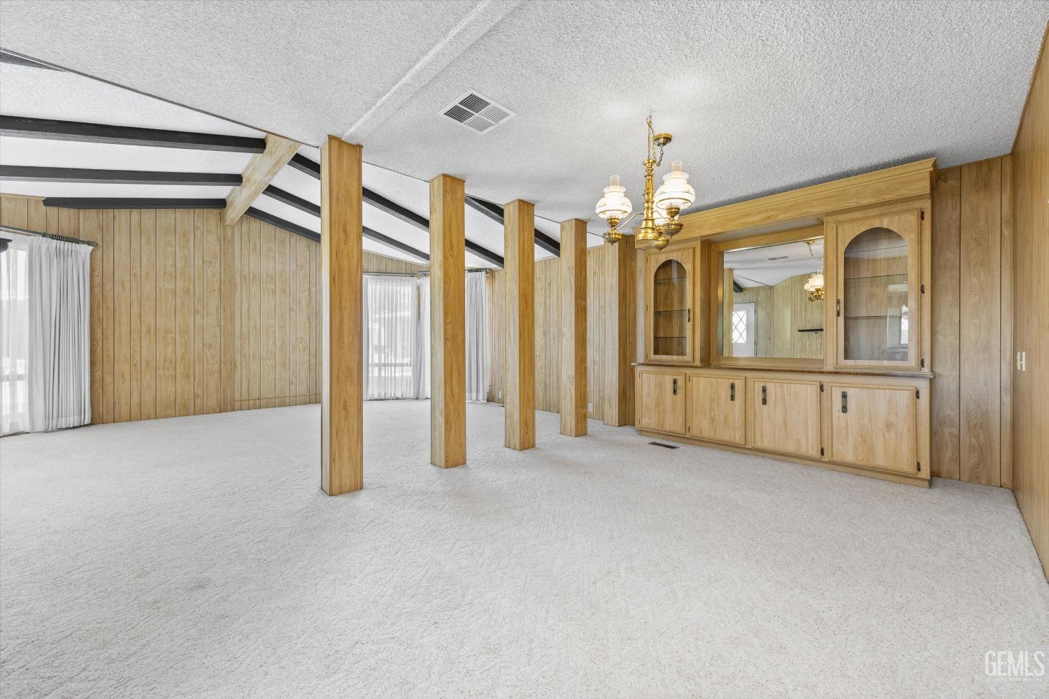 Undisclosed Address Bakersfield, CA 93306 - Photo 15 of 37 an empty room with chandelier fan and windows