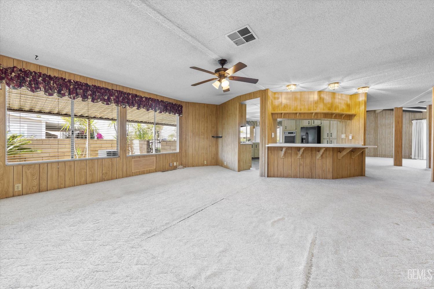 Undisclosed Address Bakersfield, CA 93306 - Photo 17 of 37 a big room with chandelier and windows