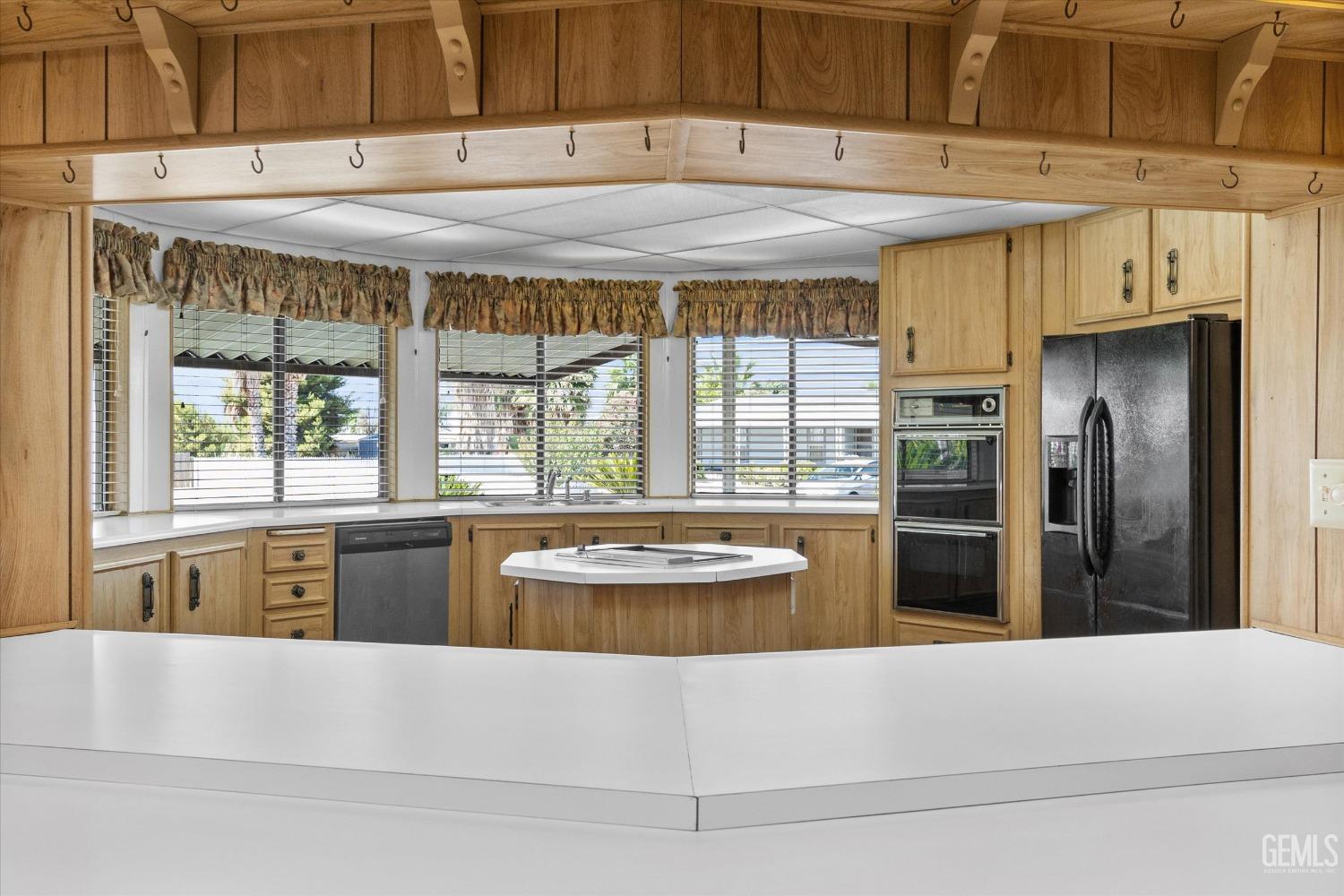Undisclosed Address Bakersfield, CA 93306 - Photo 20 of 37 a living room with stainless steel appliances kitchen island granite countertop a refrigerator a stove and a sink with large cabinets