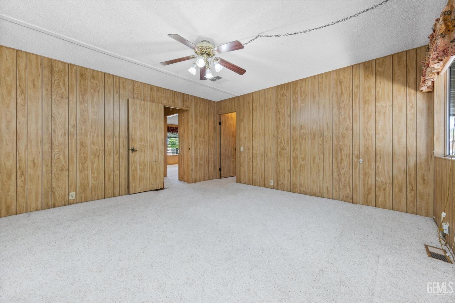 Undisclosed Address Bakersfield, CA 93306 - Photo 27 of 37 an empty room with chandelier fan