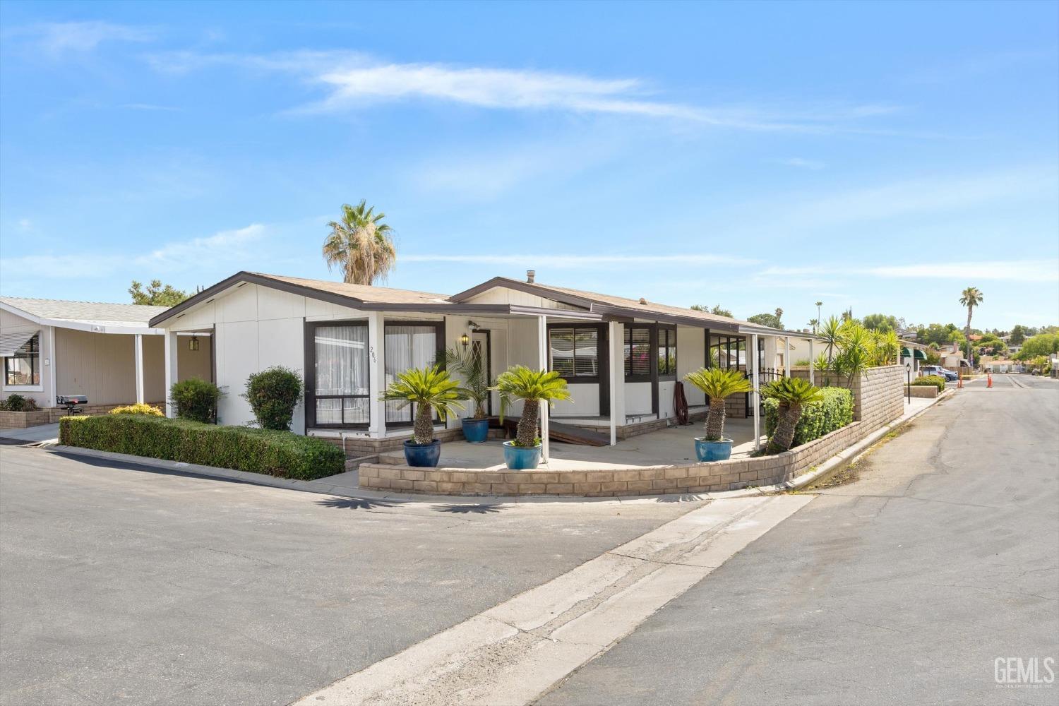 Undisclosed Address Bakersfield, CA 93306 - Photo 3 of 37 a front view of house with outdoor seating and yard in front of it