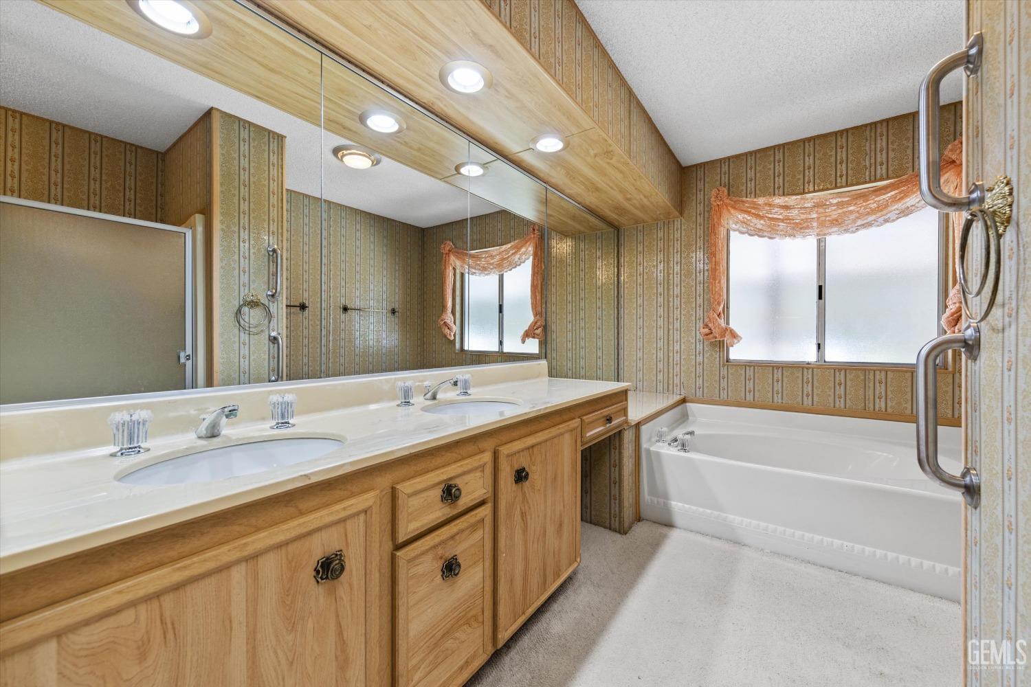 Undisclosed Address Bakersfield, CA 93306 - Photo 31 of 37 a spacious bathroom with a granite countertop sink mirror and a bathtub