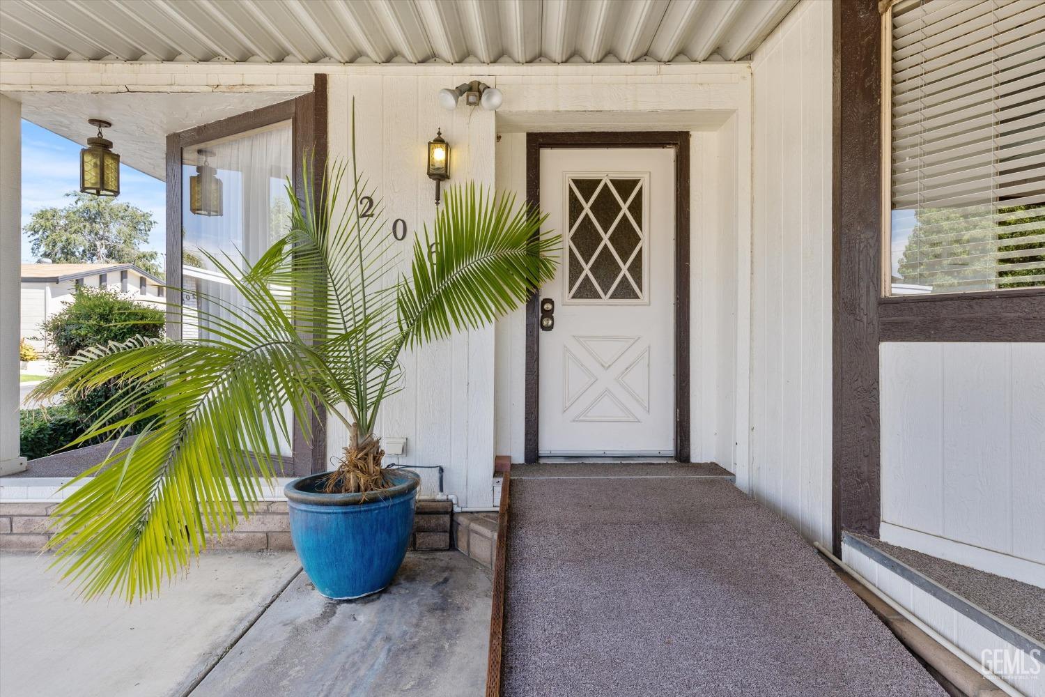 Undisclosed Address Bakersfield, CA 93306 - Photo 5 of 37 a potted plant sitting in front of a house