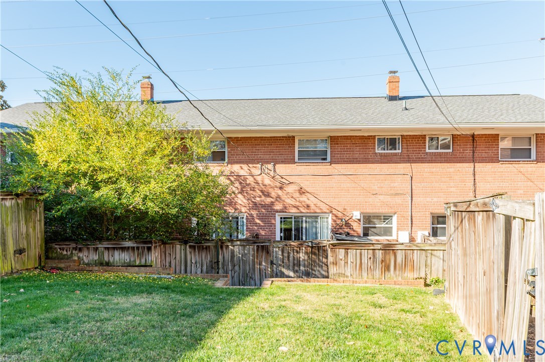 3109 North Parham Road, Unit 9 Henrico, VA 23294 - Photo 19 of 19 Back of house featuring a chimney, a fenced backya