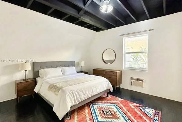 a bedroom with a bed and a lamp