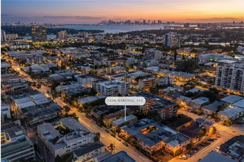 an aerial view of a residential houses with a city view