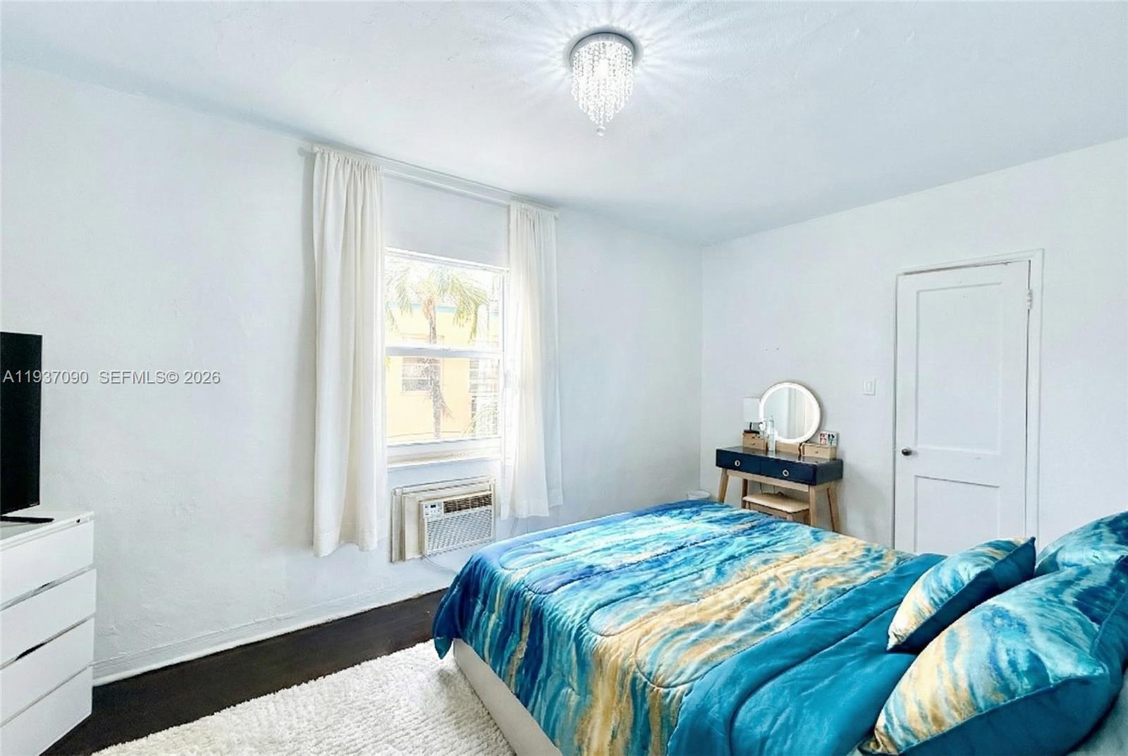 7820 Harding Avenue Miami Beach, FL 33141 - Photo 6 of 13 a bedroom with a bed and a window