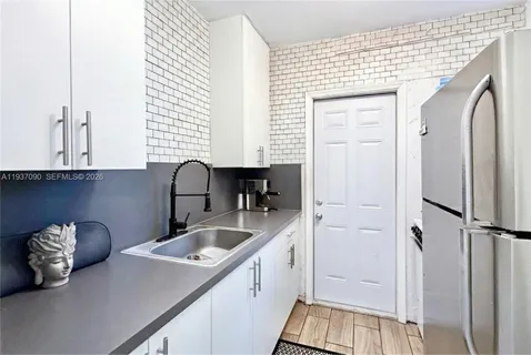 a kitchen with a sink and a refrigerator