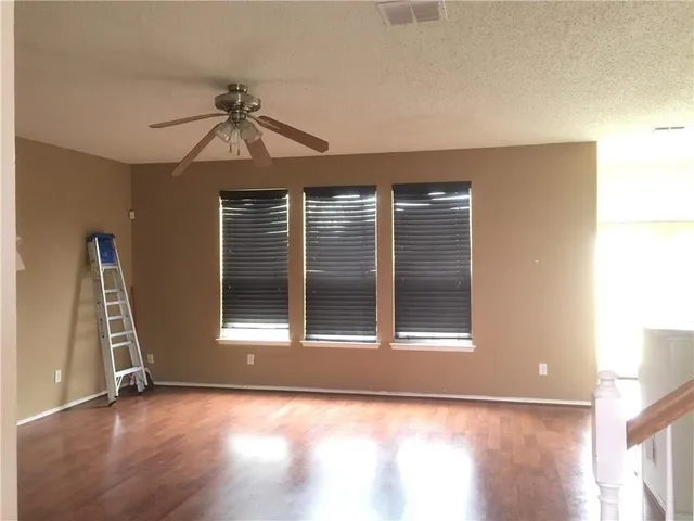a view of a kitchen with kitchen island a sink wooden floor and a counter top space