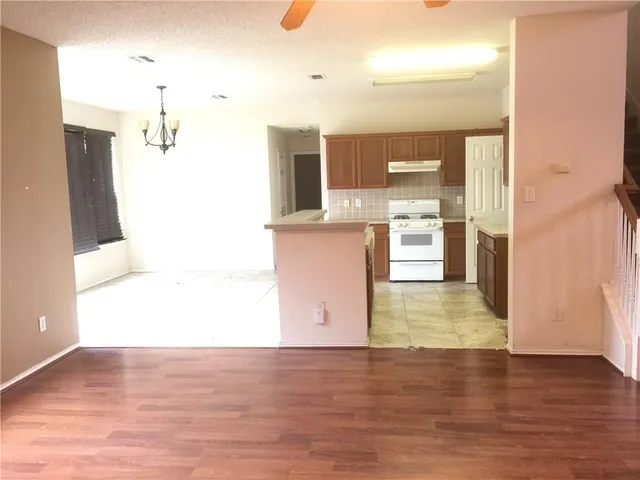 a kitchen with stainless steel appliances kitchen island granite countertop a sink and cabinets