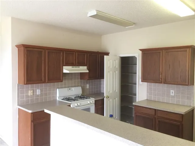a view of a kitchen cabinets and a fireplace