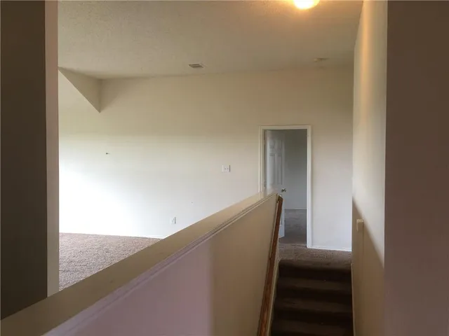 a view of a yard with wooden fence