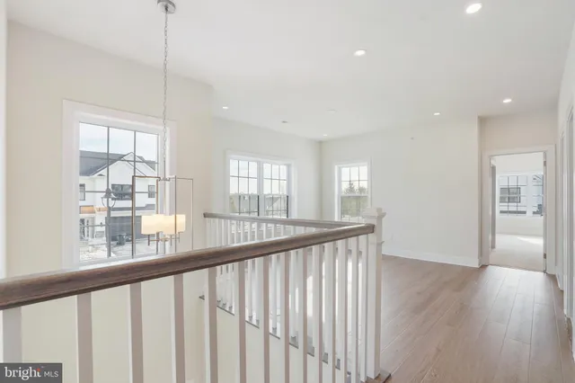 a view of a room with wooden floor and windows