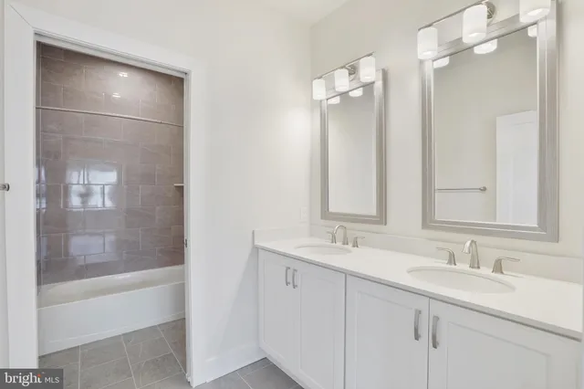 a bathroom with a shower sink vanity and mirror