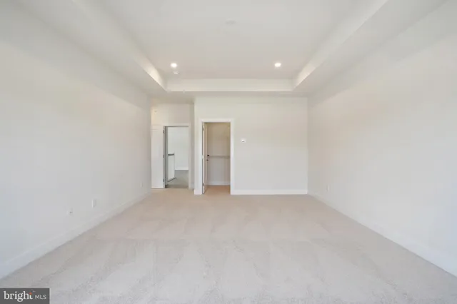 a spacious bathroom with a bathtub sink and mirror