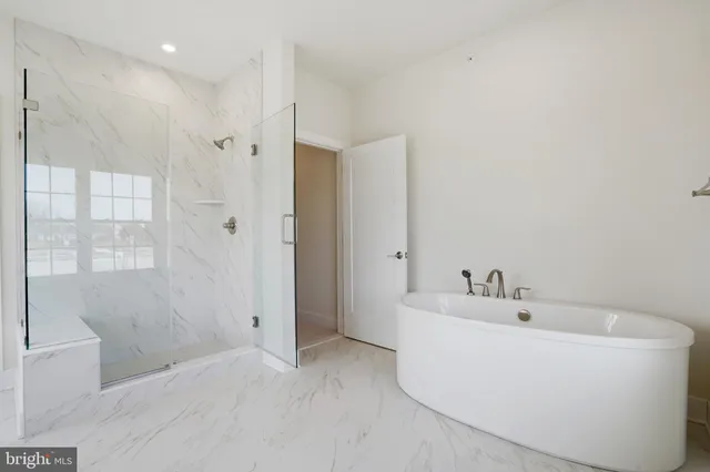a bathroom with a bathtub a sink and a window