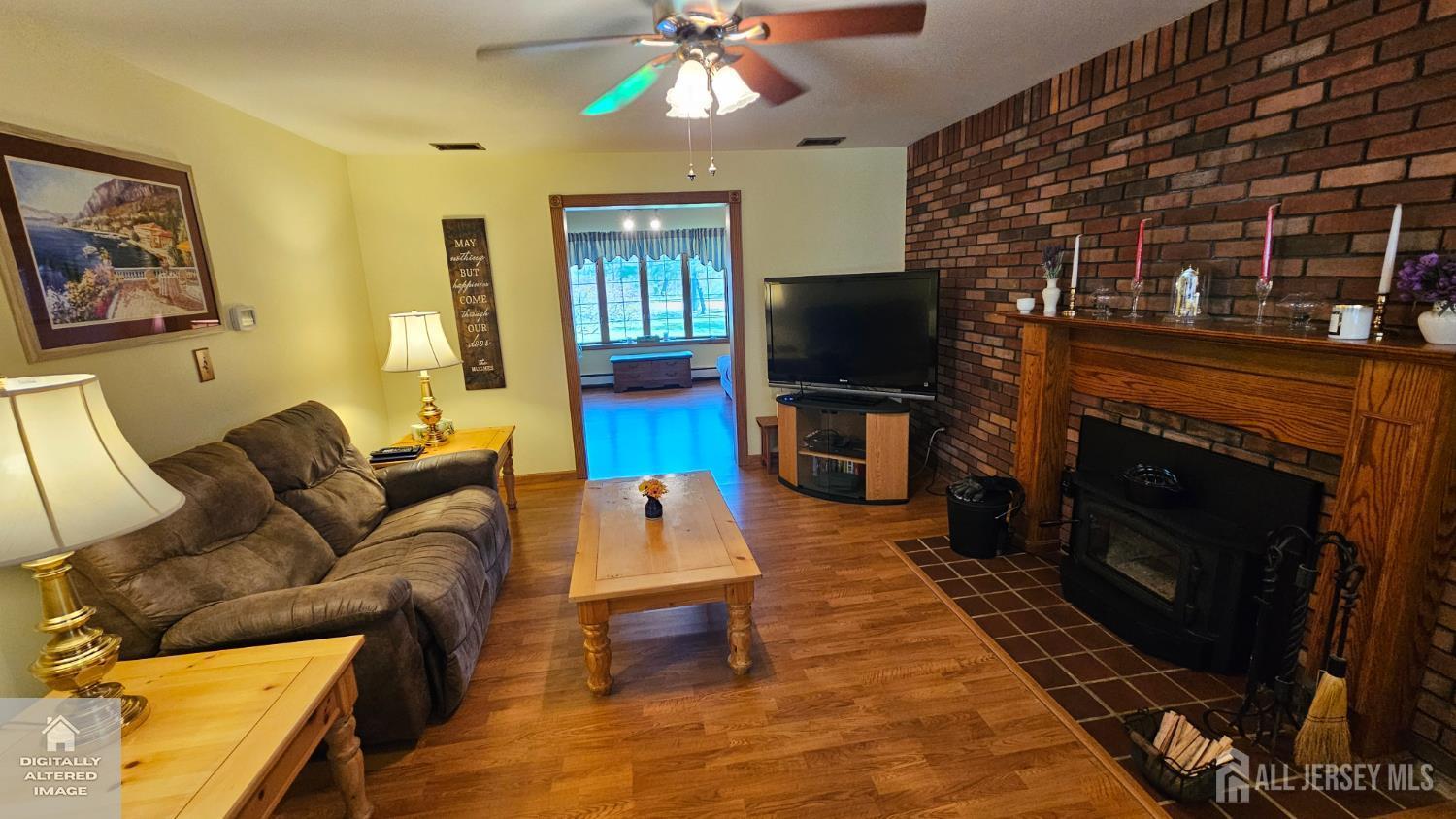 263 New Road Monmouth Junction, NJ 08852 - Photo 24 of 70 a living room with furniture a flat screen tv and a fireplace