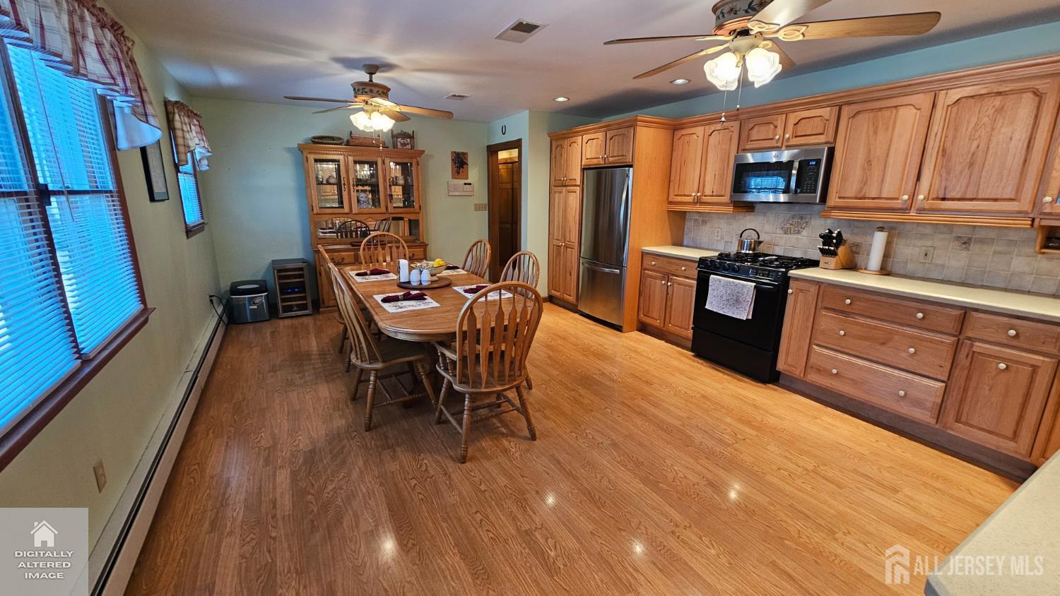 263 New Road Monmouth Junction, NJ 08852 - Photo 26 of 70 a dining room with wooden floor a chandelier a wooden table and chairs