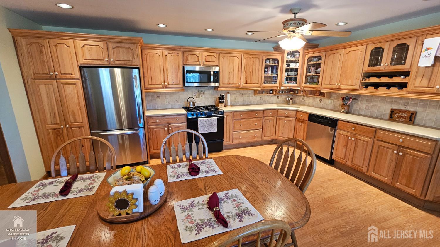 263 New Road Monmouth Junction, NJ 08852 - Photo 30 of 70 a kitchen with stainless steel appliances granite countertop a sink dishwasher a refrigerator and cabinets with wooden floor