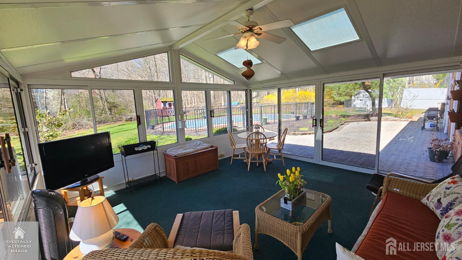 263 New Road Monmouth Junction, NJ 08852 - Photo 37 of 70 a living room with furniture a flat screen tv and a floor to ceiling window