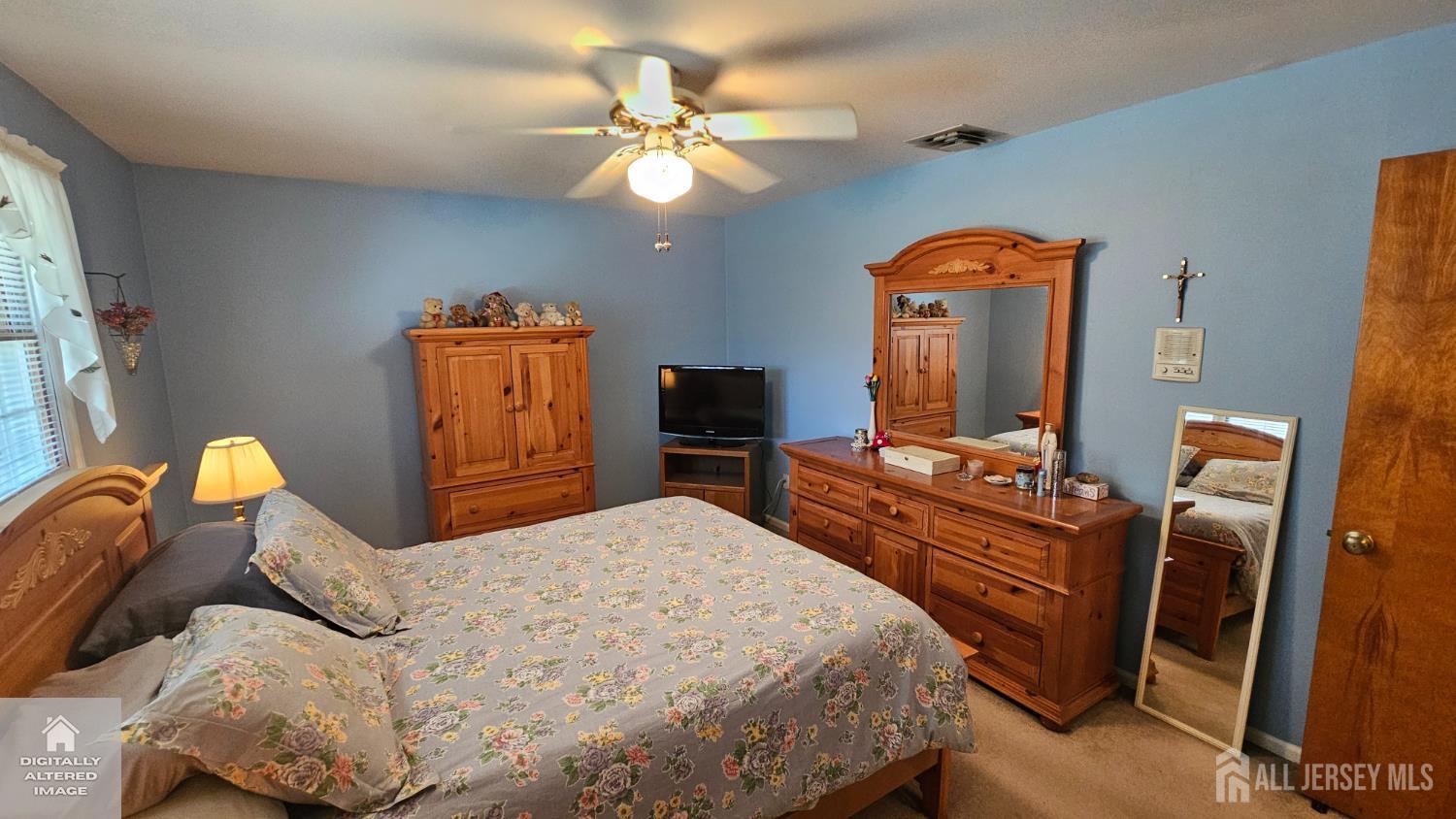 263 New Road Monmouth Junction, NJ 08852 - Photo 58 of 70 a bedroom with a bed and dresser with mirror